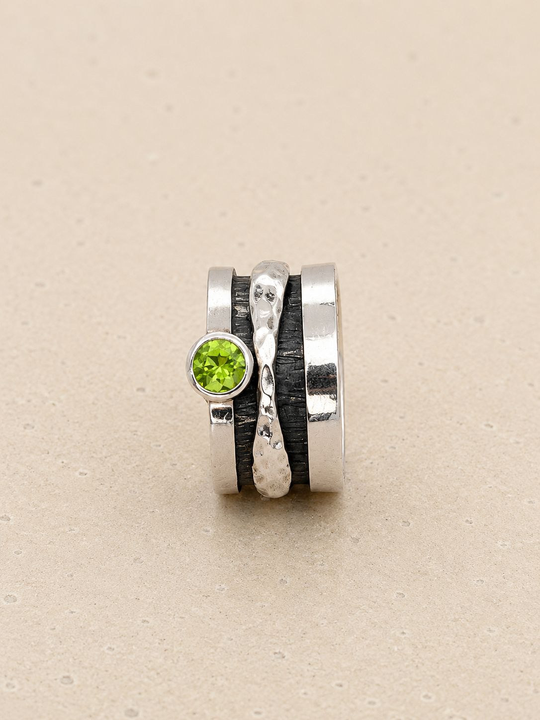 Beaten silver green stone
